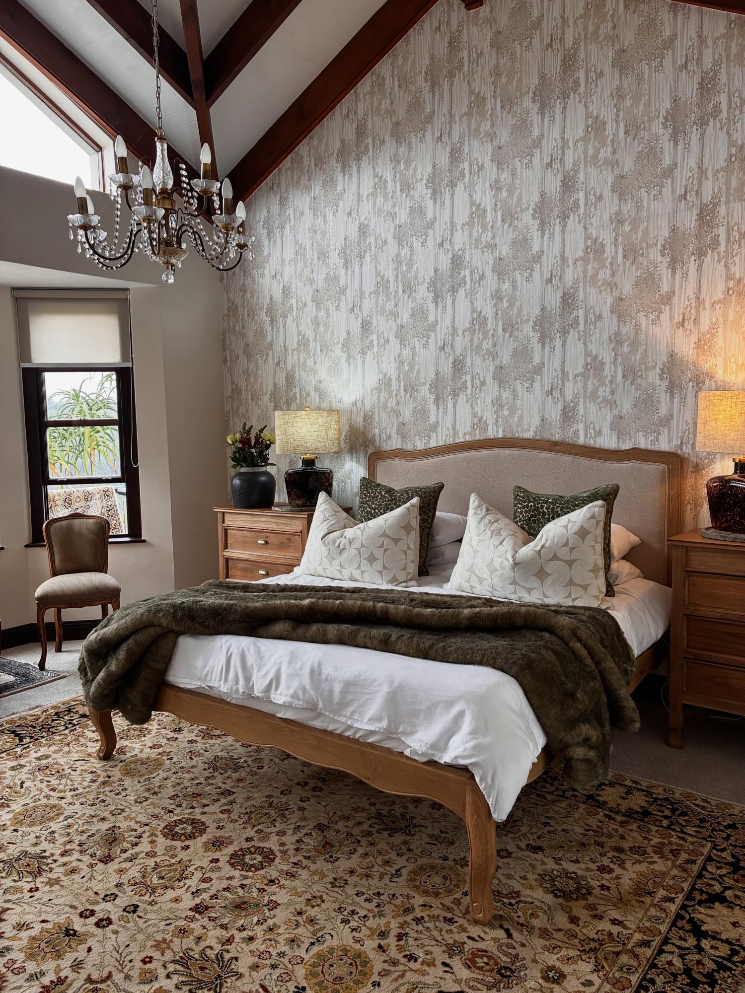 A finished bed with an upholstered oak headboard in a client's master bedroom